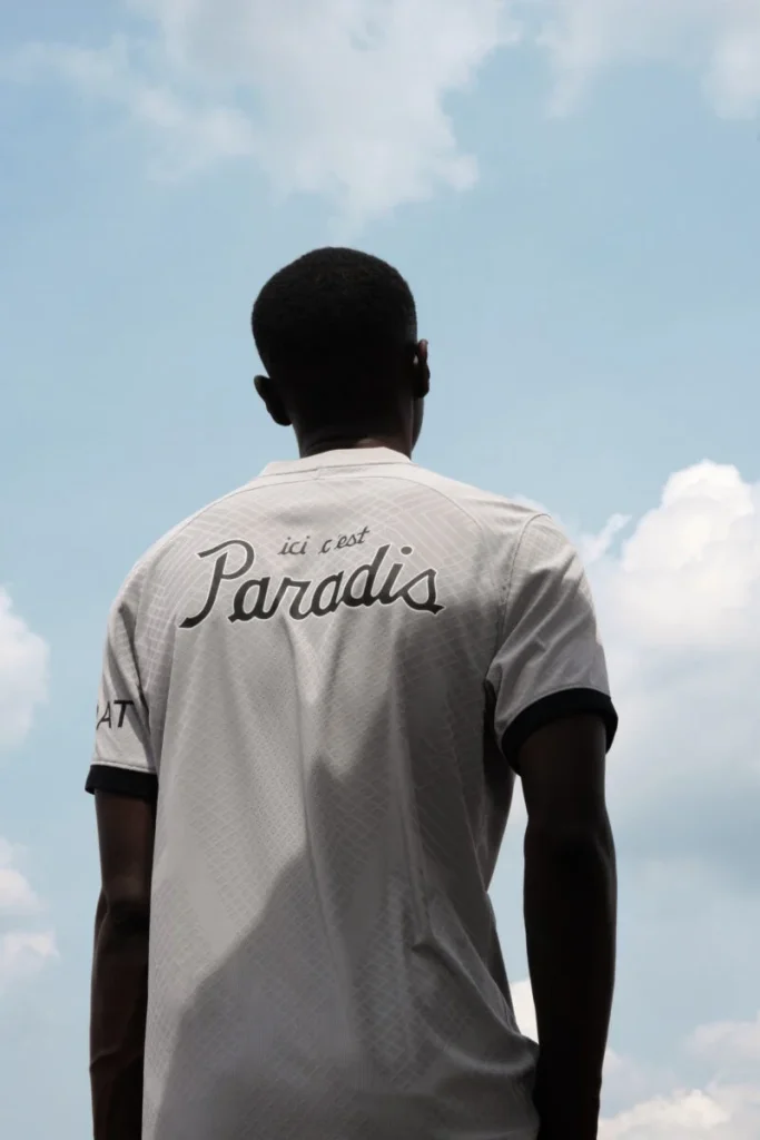 Rear view of the grey PSG collaboration jersey with Ici C’est Paradis lettering against the sky.
