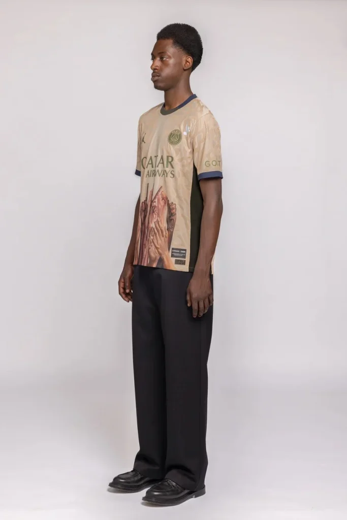 Side view of the beige PSG twelfth-title jersey showing raised hands wrapping around the torso.