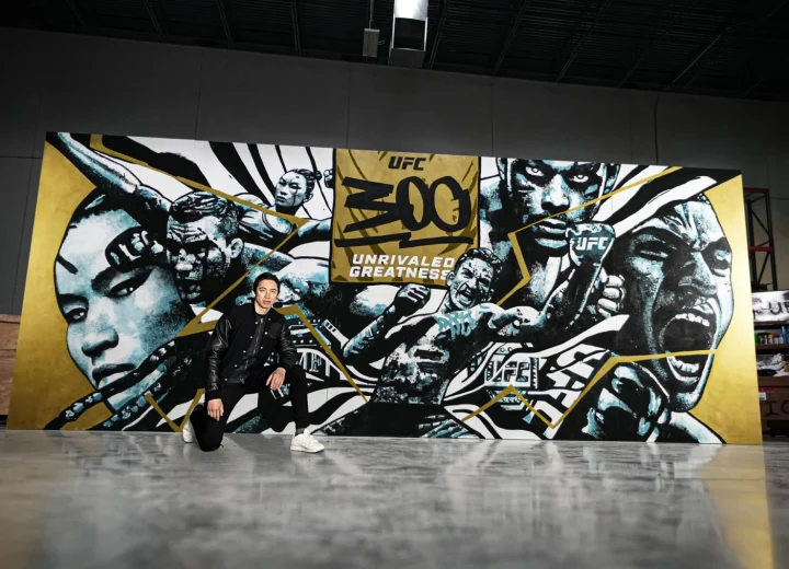 Gian Galang pictured with his wide UFC 300 mural.