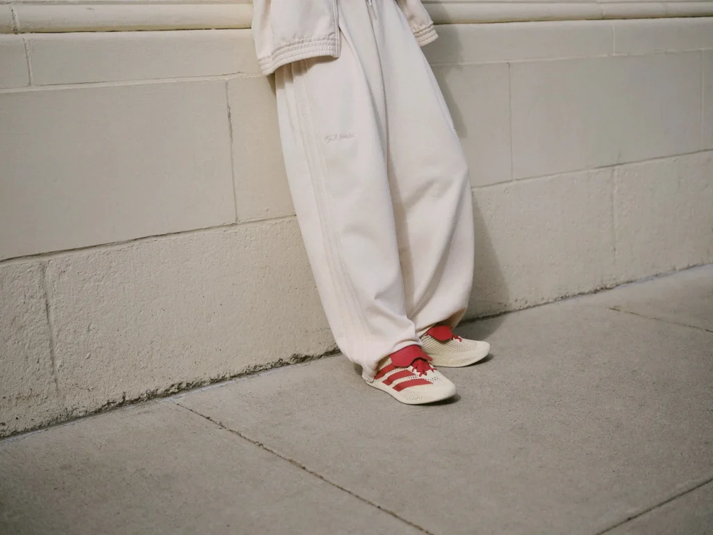Cream stadium pants with visible seam details over red and cream TW CLIMACOOL shoes.