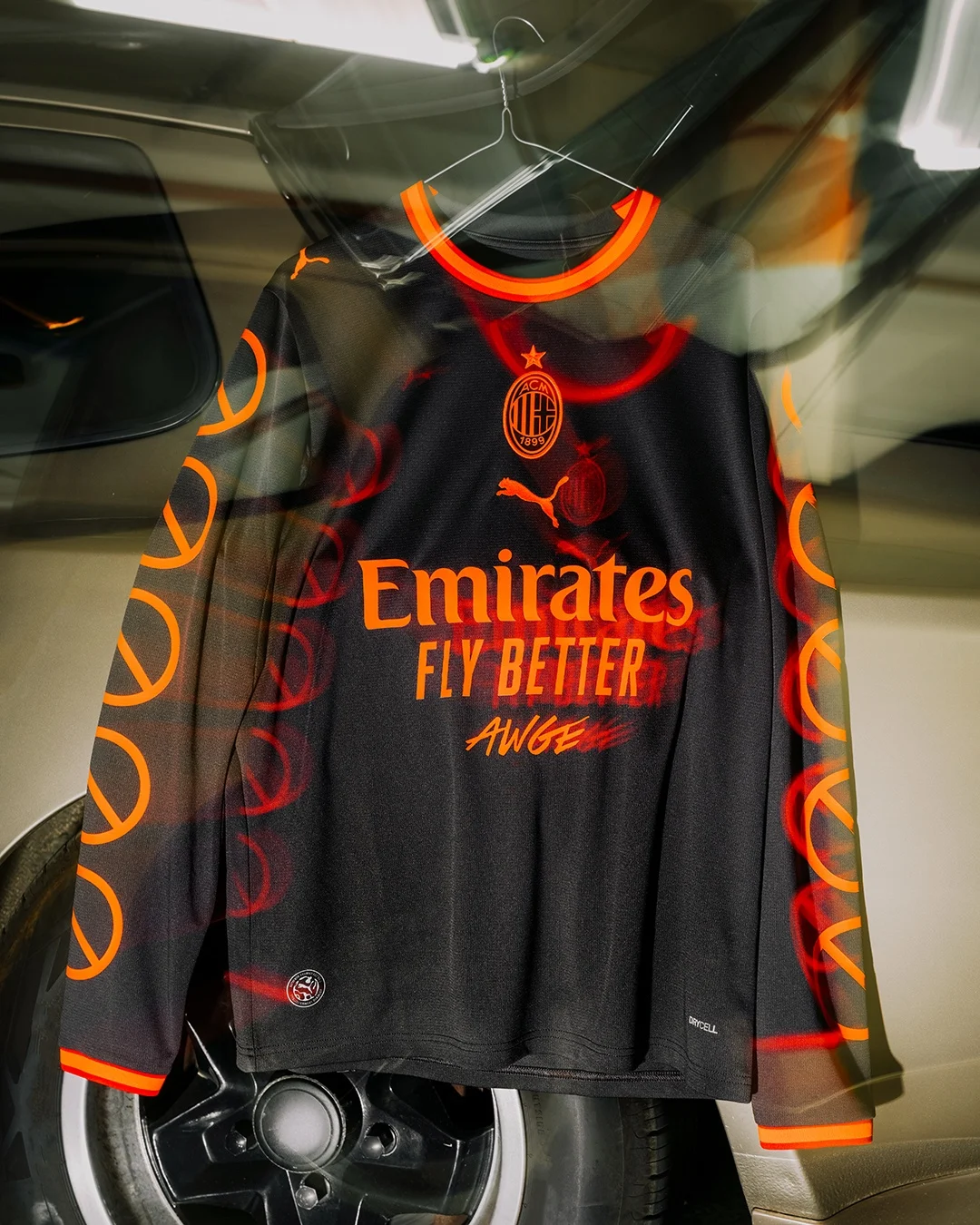 AC Milan and A$AP Rocky black long-sleeve jersey hanging inside a car with red sleeve graphics