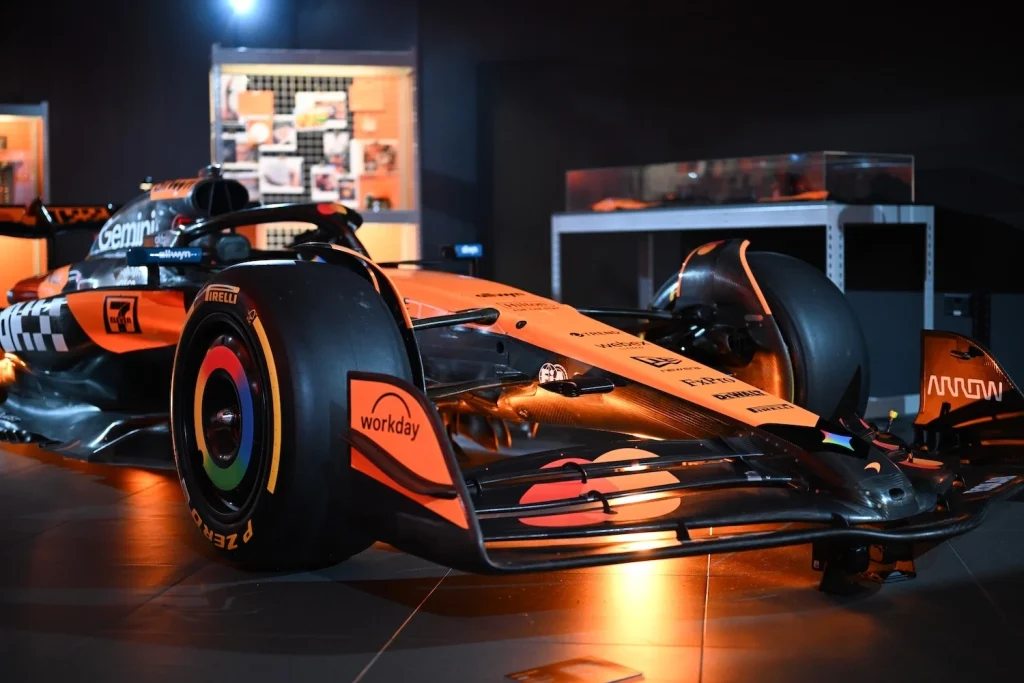 McLaren race car under papaya lighting at the Designed to Race event