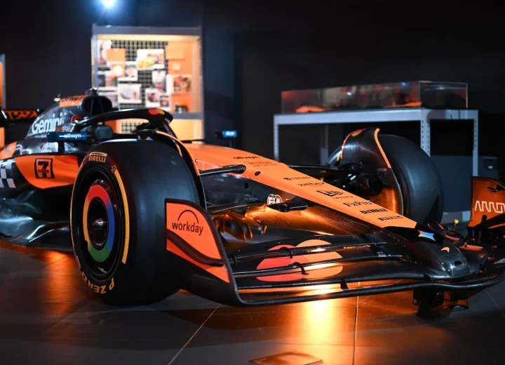McLaren race car under papaya lighting at the Designed to Race event