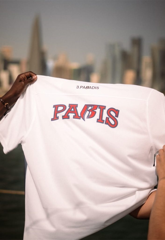 The reverse of the white pre-match jersey displays red PARIS lettering with a customised R.