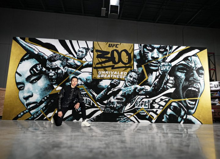 Gian Galang pictured with his wide UFC 300 mural.
